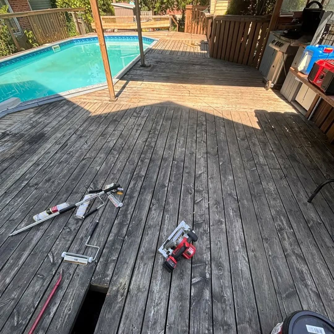 Worn, weathered pool deck boards before restoration