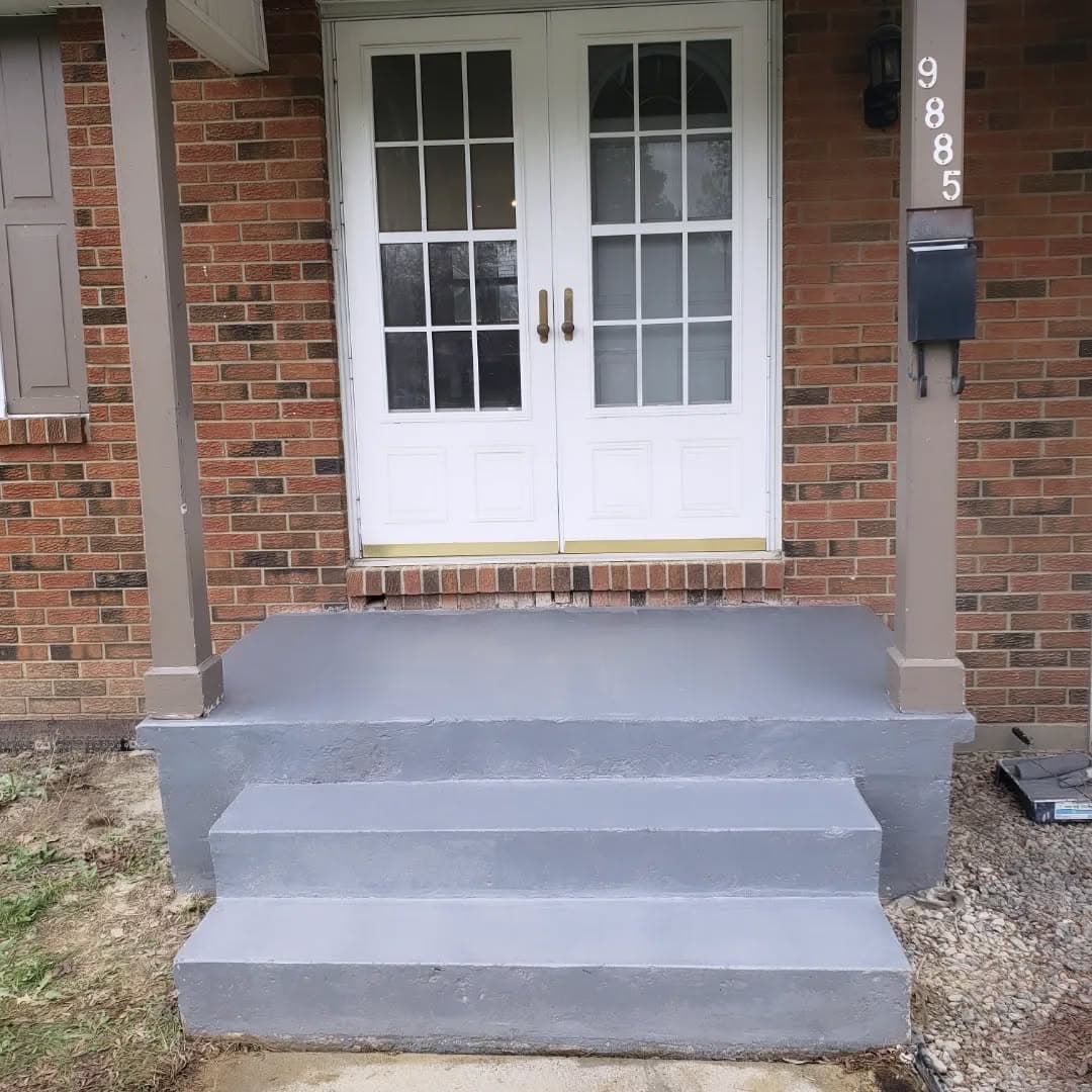 The same porch with patched concrete and fresh paint